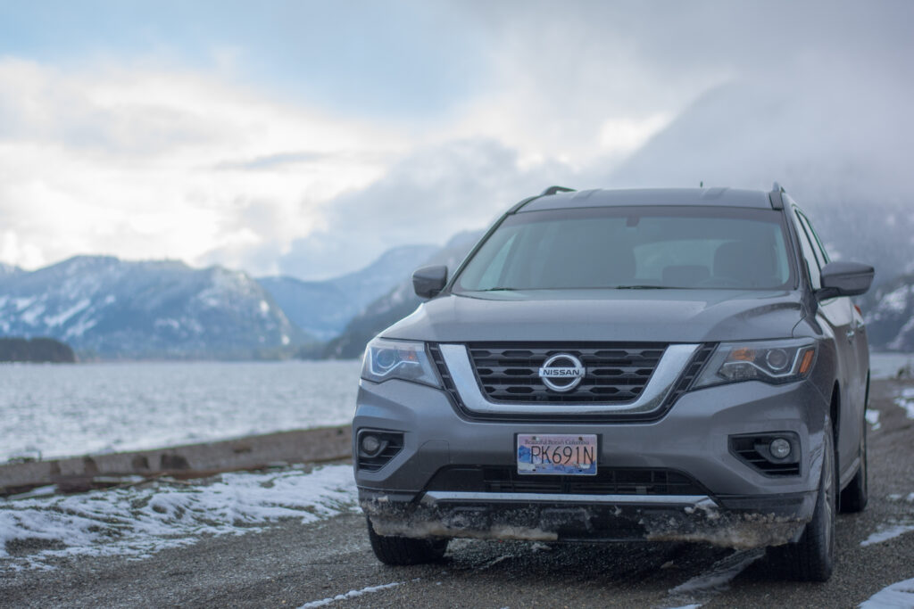 Photo of Nissan Pathfinder on Vancouver Island Beach with Snowy Mountains in the background
